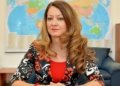 Жена с дълга коса и усмивка.